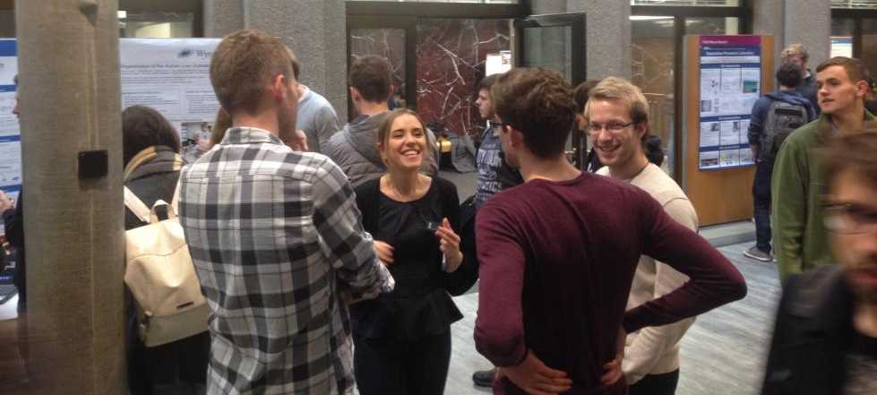 One team member discussing the lab's research to interested bachelor students