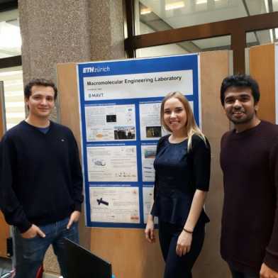 Team members in front of the "Meet your lab" poster
